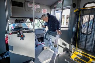 After shopping at The Corner Store, Whitehall resident Bruce Ball boards a Whitehall Public Transportation bus driven by LeRoy Murphy Feb. 21, 2020. (Ball has since passed away.)